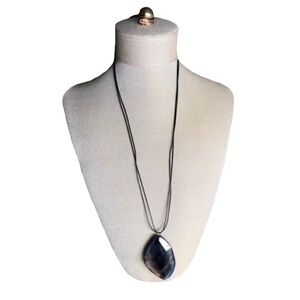 Polished purple stone necklace on black cord